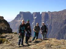 Linda McMillan, Ian Cox, Trevor Sandwith, and Dave Morris represented the world climbing communitiy on Sentinel Peak where the Didima Declaration was promulgated. The dramatic spike of The Devil's Tooth  is in the background. 